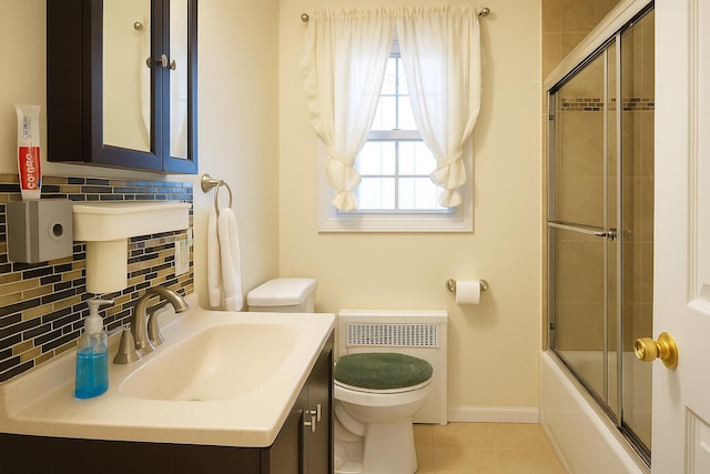 118-37 180th St, Jamaica, NY 11434 - bathroom with toilet, backsplash, tile patterned flooring, bath / shower combo with glass door, and baseboards