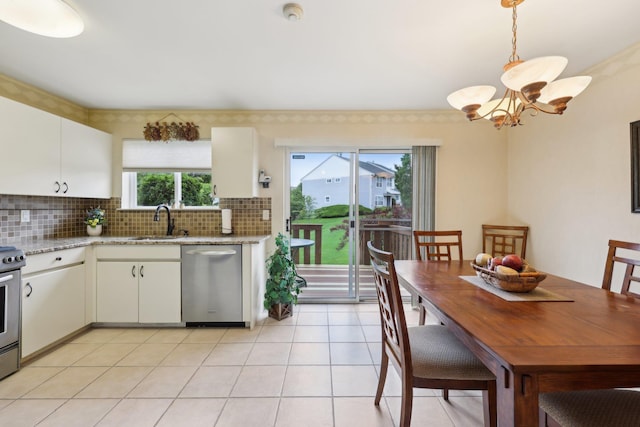22 Knightsbridge Ct, Nanuet, NY 10954 - kitchen featuring stainless steel appliances, a sink, a chandelier, decorative backsplash, and white cabinetry