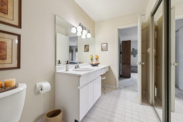 22 Knightsbridge Ct, Nanuet, NY 10954 - bathroom featuring toilet, vanity, tile patterned flooring, and baseboards