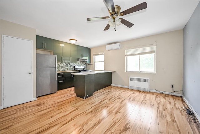 148-35 58th Ave, Flushing, NY 11355 - kitchen featuring stainless steel appliances, radiator heating unit, an AC wall unit, green cabinets, and a peninsula