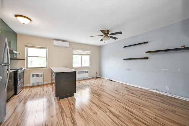 148-35 58th Ave, Flushing, NY 11355 - kitchen with radiator, a wall mounted AC, stainless steel range with electric cooktop, and a ceiling fan