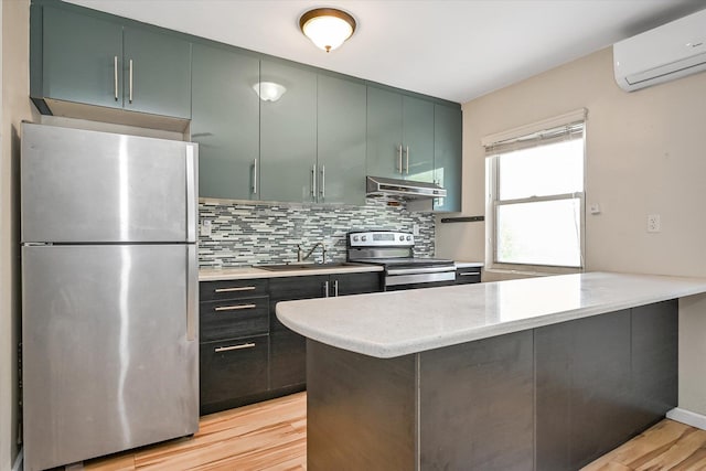 148-35 58th Ave, Flushing, NY 11355 - kitchen featuring stainless steel appliances, a sink, a wall unit AC, under cabinet range hood, and light wood-type flooring