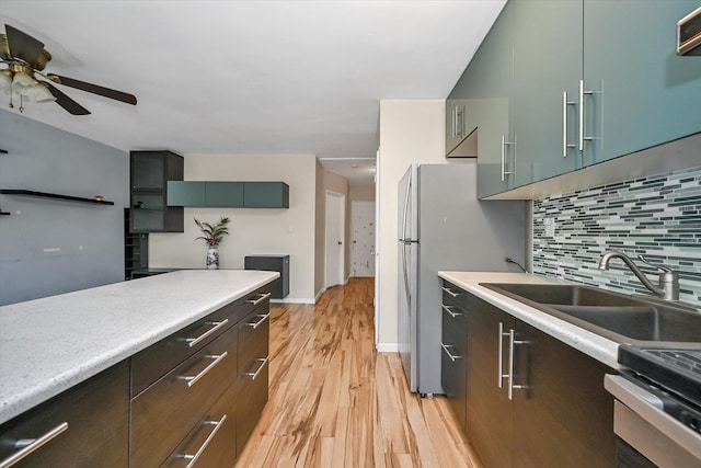 148-35 58th Ave, Flushing, NY 11355 - kitchen with light wood-style flooring, ceiling fan, decorative backsplash, and light countertops