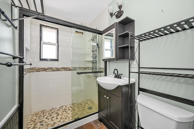 148-35 58th Ave, Flushing, NY 11355 - bathroom with a stall shower, toilet, vanity, and wood finished floors