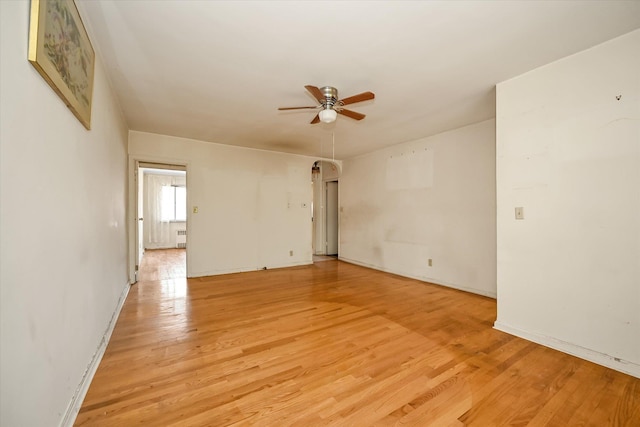 148-35 58th Ave, Flushing, NY 11355 - spare room with a ceiling fan, light wood finished floors, baseboards, and radiator