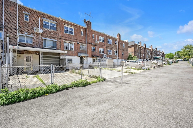 148-35 58th Ave, Flushing, NY 11355 - view of property with a residential view, an attached garage, and fence