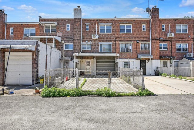 148-35 58th Ave, Flushing, NY 11355 - back of property with a fenced front yard and brick siding