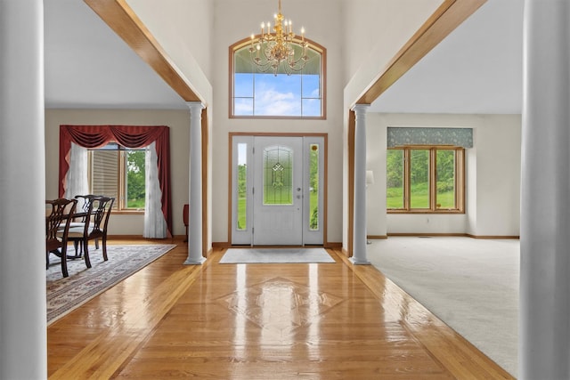 115 Moffat Rd, Washingtonville, NY 10992 - foyer with decorative columns, a chandelier, plenty of natural light, and a towering ceiling