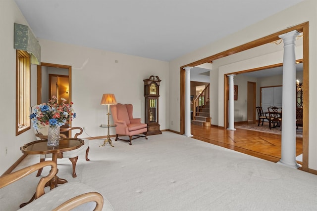 115 Moffat Rd, Washingtonville, NY 10992 - living area featuring decorative columns, carpet floors, and baseboards
