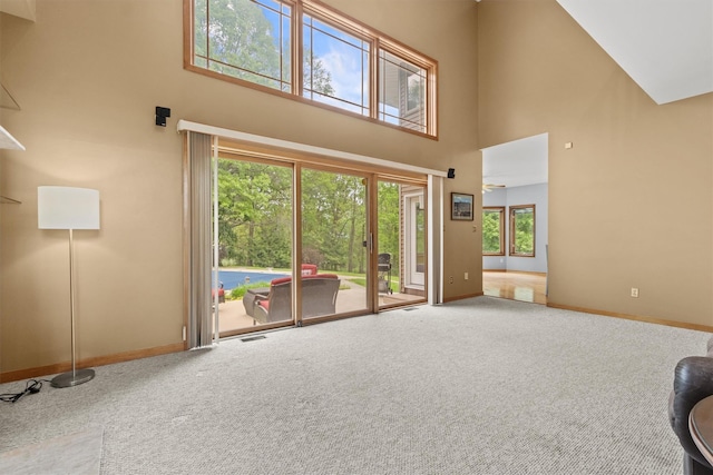 115 Moffat Rd, Washingtonville, NY 10992 - unfurnished living room featuring a high ceiling, baseboards, and carpet