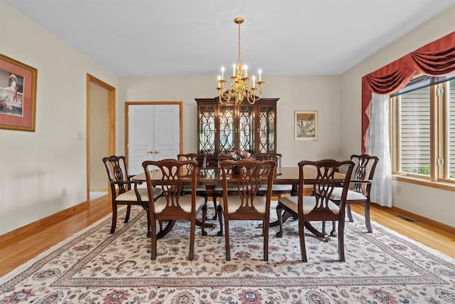 115 Moffat Rd, Washingtonville, NY 10992 - dining space featuring a chandelier, light wood finished floors, and baseboards