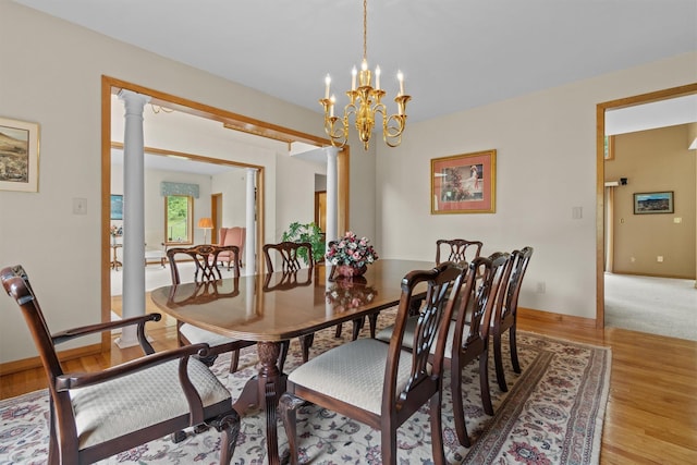 115 Moffat Rd, Washingtonville, NY 10992 - dining space with a chandelier, light wood-style floors, and baseboards