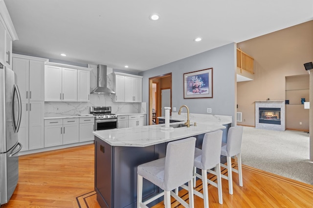 115 Moffat Rd, Washingtonville, NY 10992 - kitchen featuring wall chimney exhaust hood, stainless steel appliances, a sink, a peninsula, and a breakfast bar area