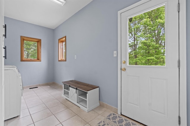 115 Moffat Rd, Washingtonville, NY 10992 - doorway to outside featuring washer / dryer, light tile patterned flooring, and baseboards
