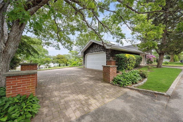 9 Lakeland Ave, Patchogue, NY 11772 - view of side of home featuring a garage and decorative driveway