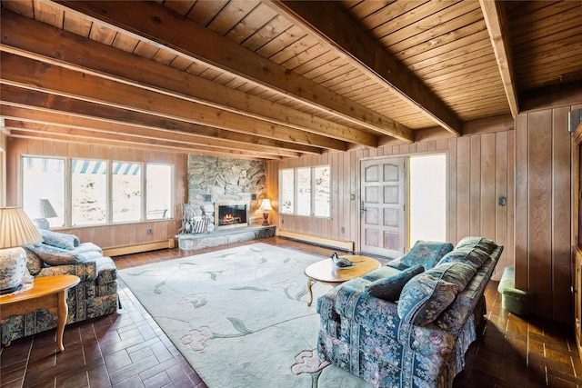 9 Lakeland Ave, Patchogue, NY 11772 - living area featuring baseboard heating, wood walls, wooden ceiling with exposed beams, a stone fireplace, and healthy amount of natural light