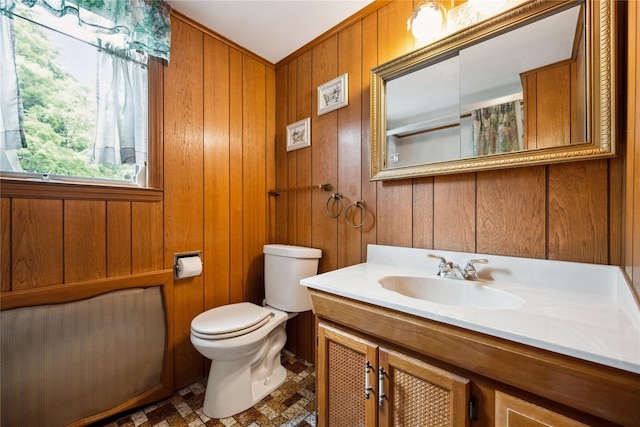 9 Lakeland Ave, Patchogue, NY 11772 - bathroom with vanity, toilet, and wooden walls