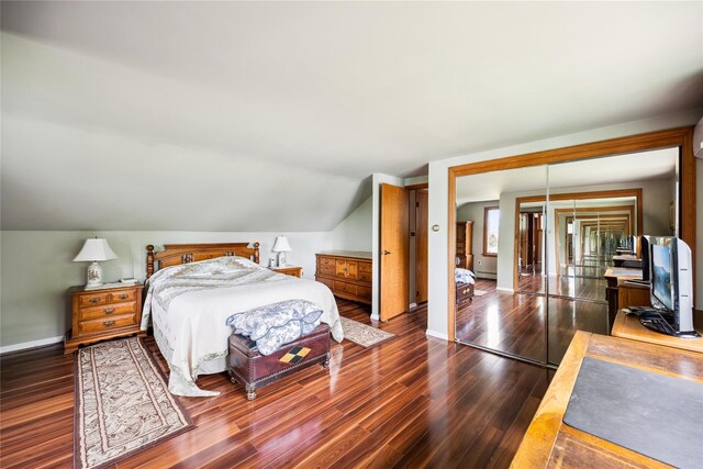 9 Lakeland Ave, Patchogue, NY 11772 - bedroom featuring dark wood-style flooring, lofted ceiling, and baseboards