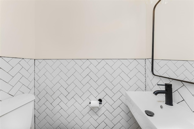 half bathroom with tile walls and toilet