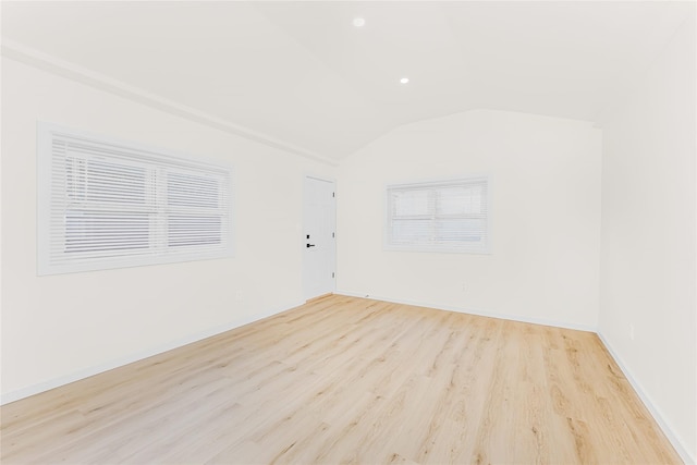 additional living space featuring light wood-style flooring, vaulted ceiling, recessed lighting, and baseboards