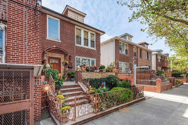 view of front facade with brick siding and fence