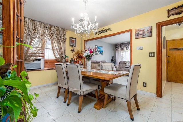 dining space featuring a chandelier, cooling unit, and baseboards