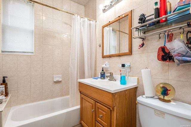 bathroom with toilet, vanity, shower / bathtub combination with curtain, and tile walls
