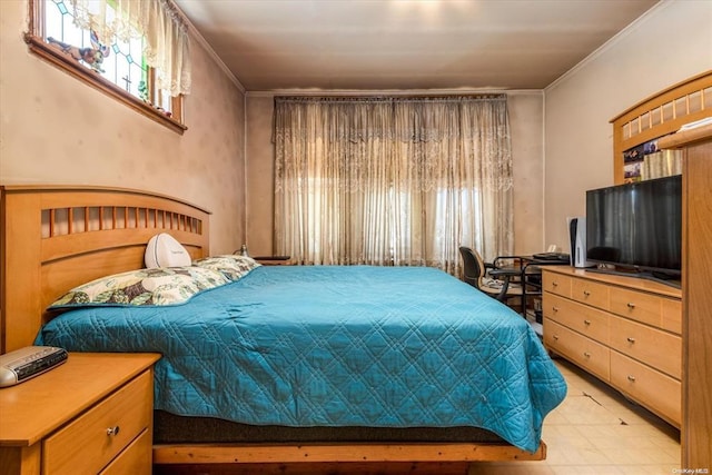 bedroom featuring multiple windows and light floors