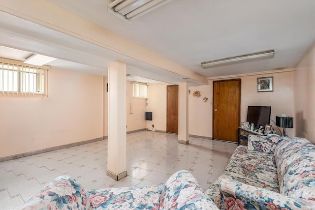 living room with baseboards and light floors