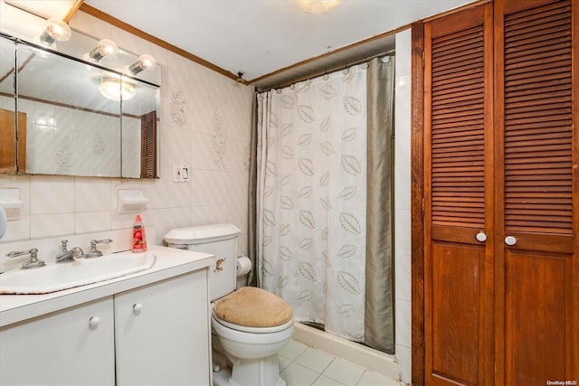 bathroom featuring toilet, tile walls, tile patterned flooring, vanity, and a closet