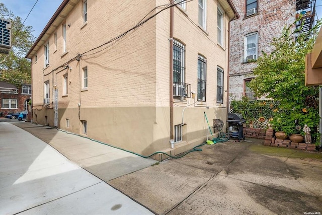 view of side of home featuring brick siding