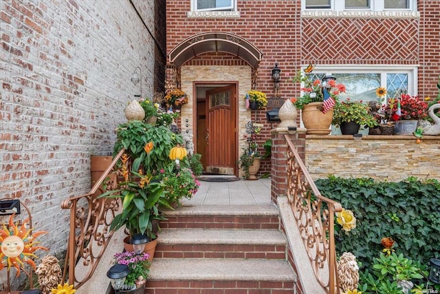view of exterior entry with brick siding
