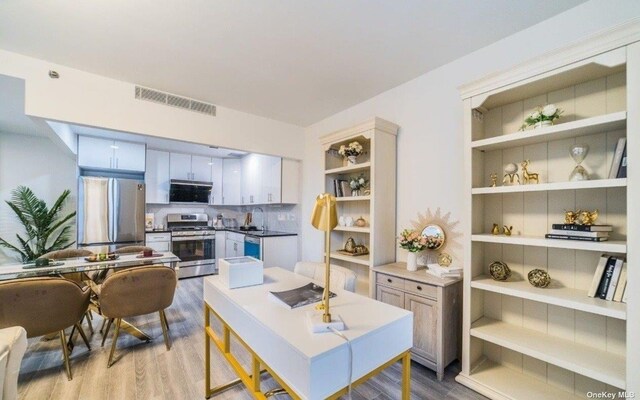 144-27 Sanford Ave Unit 2K, Flushing, NY 11355 - kitchen featuring appliances with stainless steel finishes, open shelves, wood finished floors, and a sink