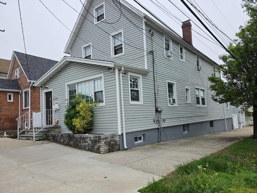 128-04 Gotham Rd, South Ozone Park, NY 11420 - view of home's exterior with a chimney