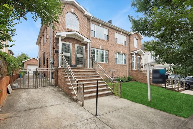 61-31 136th St, Flushing, NY 11367 - view of front facade featuring an outdoor structure, brick siding, and a garage