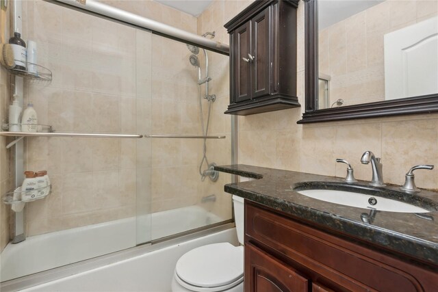 61-31 136th St, Flushing, NY 11367 - bathroom with tasteful backsplash, toilet, combined bath / shower with glass door, and vanity