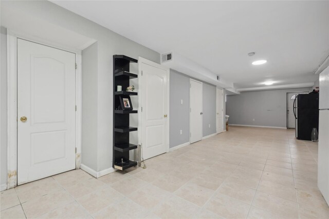 61-31 136th St, Flushing, NY 11367 - finished basement featuring freestanding refrigerator, light tile patterned floors, and baseboards