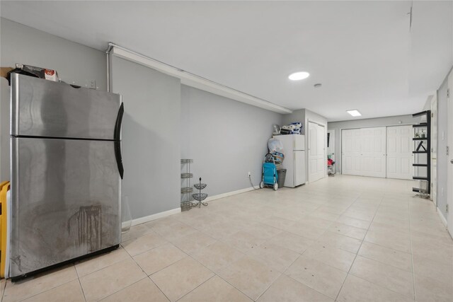 61-31 136th St, Flushing, NY 11367 - basement featuring freestanding refrigerator, baseboards, light tile patterned flooring, and recessed lighting