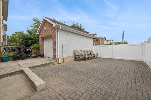 61-31 136th St, Flushing, NY 11367 - view of patio / terrace with fence, a garage, and an outbuilding