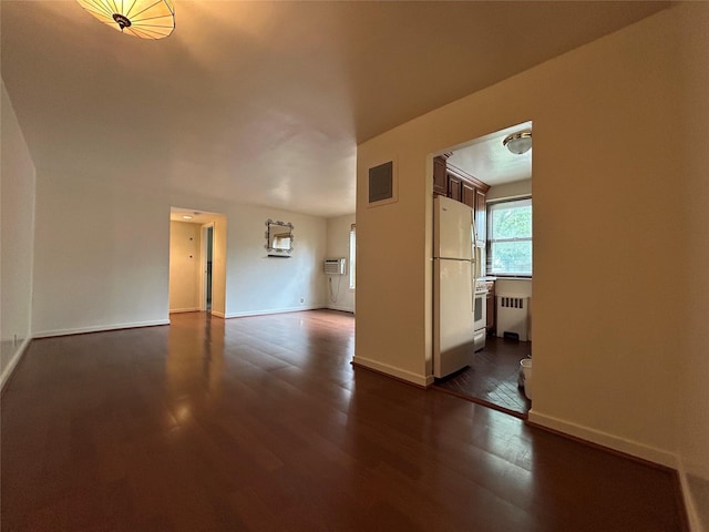 8 W Mill Dr Unit 1B, Great Neck, NY 11021 - spare room featuring radiator, dark wood-style floors, and baseboards