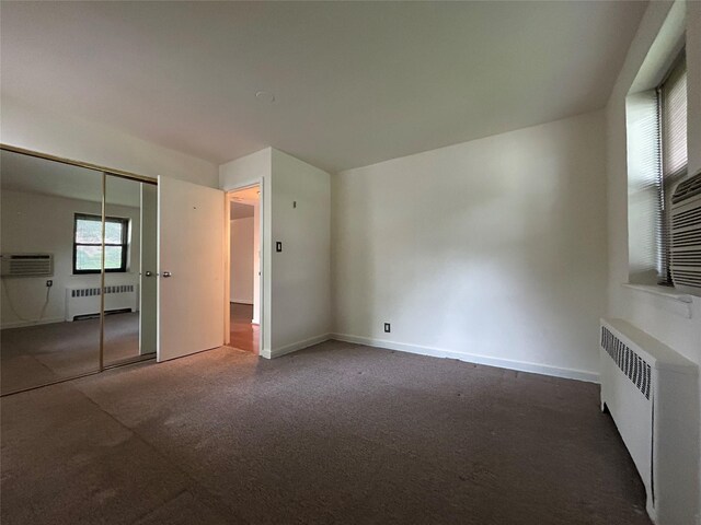 8 W Mill Dr Unit 1B, Great Neck, NY 11021 - unfurnished bedroom featuring radiator, carpet flooring, a closet, and baseboards