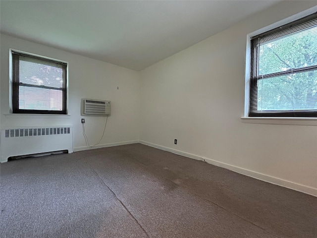 8 W Mill Dr Unit 1B, Great Neck, NY 11021 - empty room featuring radiator heating unit, a wall mounted AC, and baseboards