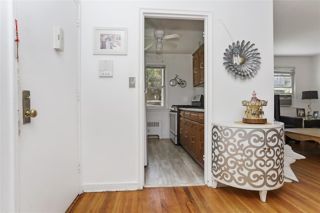 165 Columbus Ave Unit 1B, West Harrison, NY 10604 - hall featuring light wood-style floors and radiator heating unit