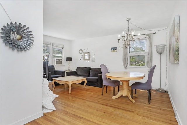 165 Columbus Ave Unit 1B, West Harrison, NY 10604 - dining room featuring a chandelier, light wood-style flooring, baseboards, and cooling unit