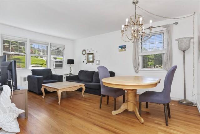 165 Columbus Ave Unit 1B, West Harrison, NY 10604 - dining space with a chandelier, plenty of natural light, light wood-type flooring, and cooling unit