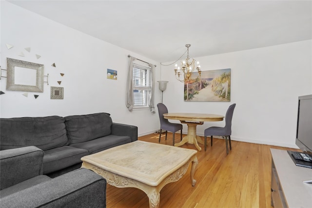 165 Columbus Ave Unit 1B, West Harrison, NY 10604 - living room with a chandelier, light wood finished floors, and baseboards