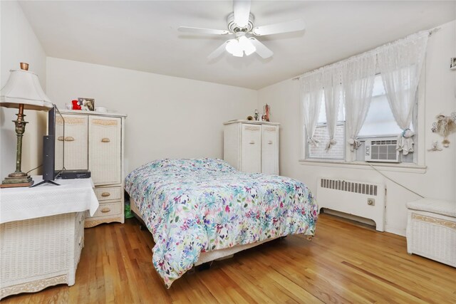165 Columbus Ave Unit 1B, West Harrison, NY 10604 - bedroom featuring radiator, wood finished floors, and ceiling fan