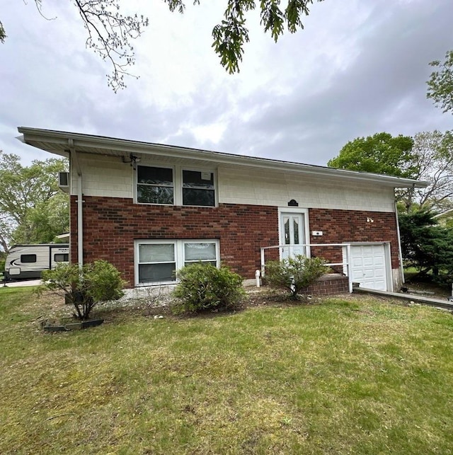 bi-level home with a front yard, brick siding, and french doors