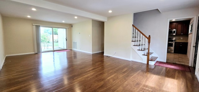 6 Arizona Ave, Syosset, NY 11791 - spare room featuring dark wood-type flooring, stairs, recessed lighting, and baseboards