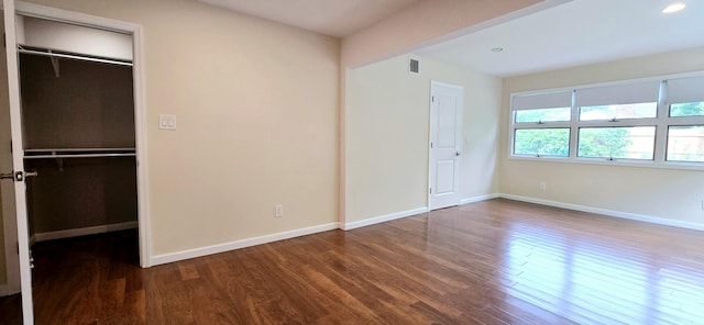 6 Arizona Ave, Syosset, NY 11791 - unfurnished bedroom with wood finished floors, baseboards, a walk in closet, a closet, and recessed lighting